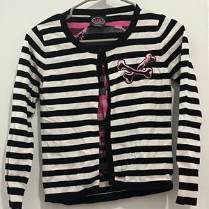 Pink skull on black and white striped shirt